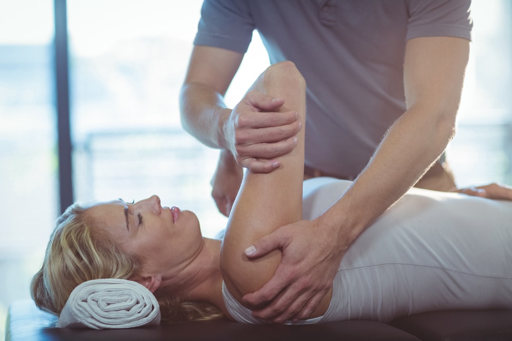 Woman receiving osteopathic treatment to shoulder